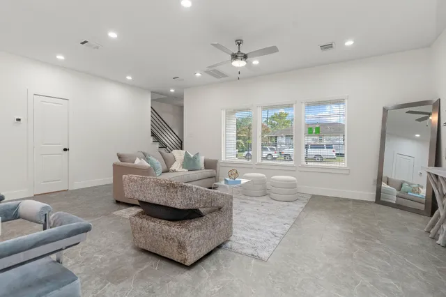 a living room with furniture and a large window