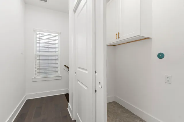 an empty room with a window and a ceiling fan