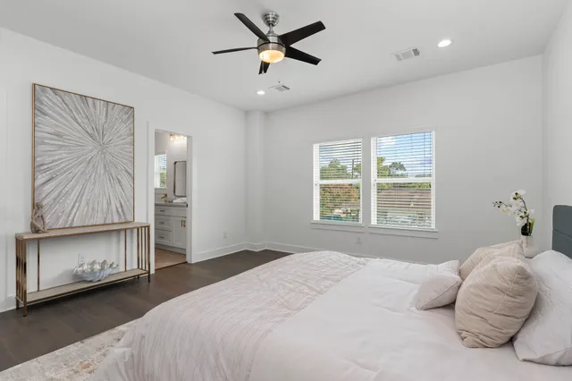 a bathroom with a granite countertop sink a mirror and a bathtub