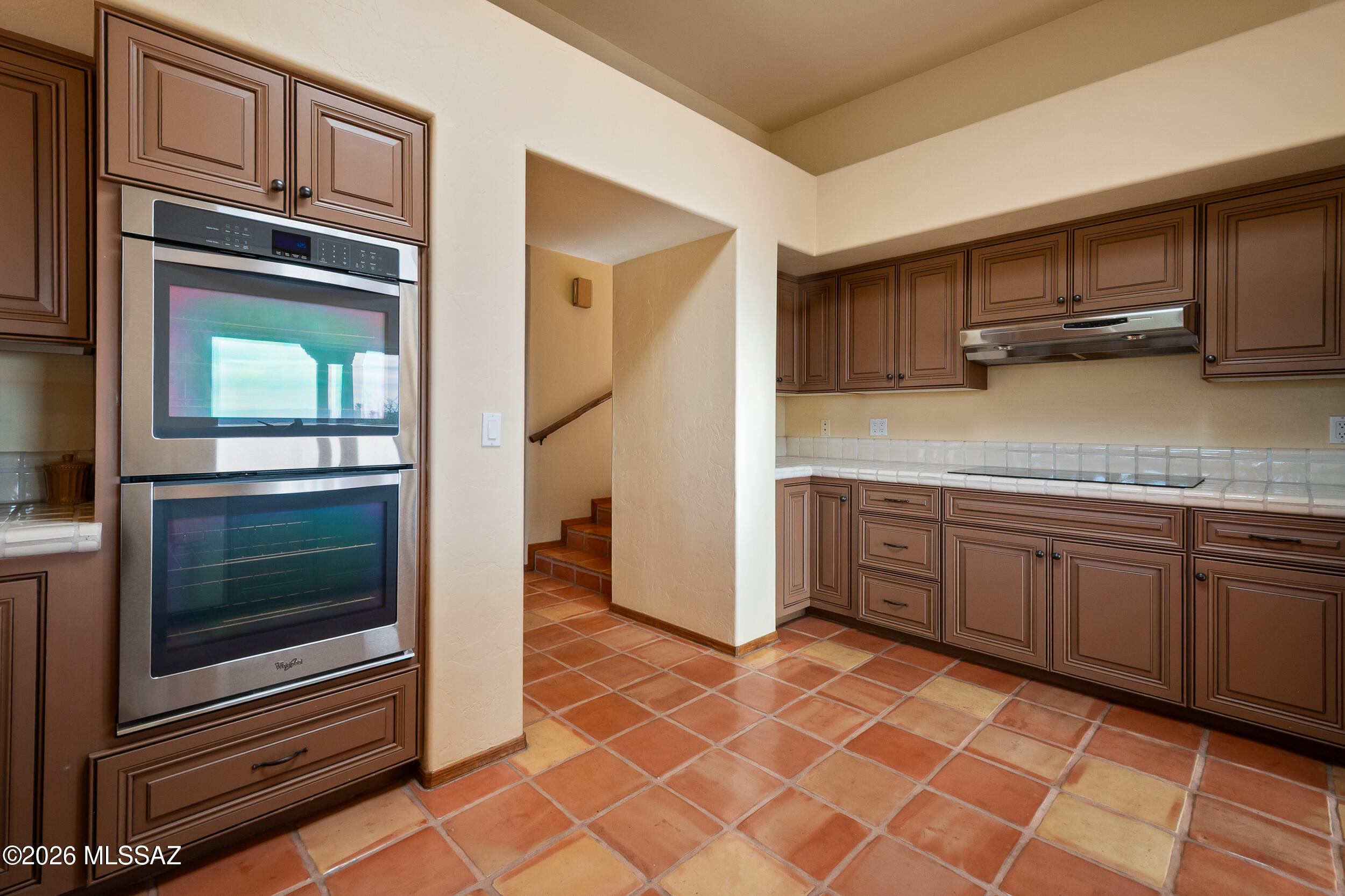 13630 East Sahuaro Sunset Road Tucson, AZ 85749 - Photo 13 of 47 a kitchen with stainless steel appliances granite countertop a refrigerator and a stove