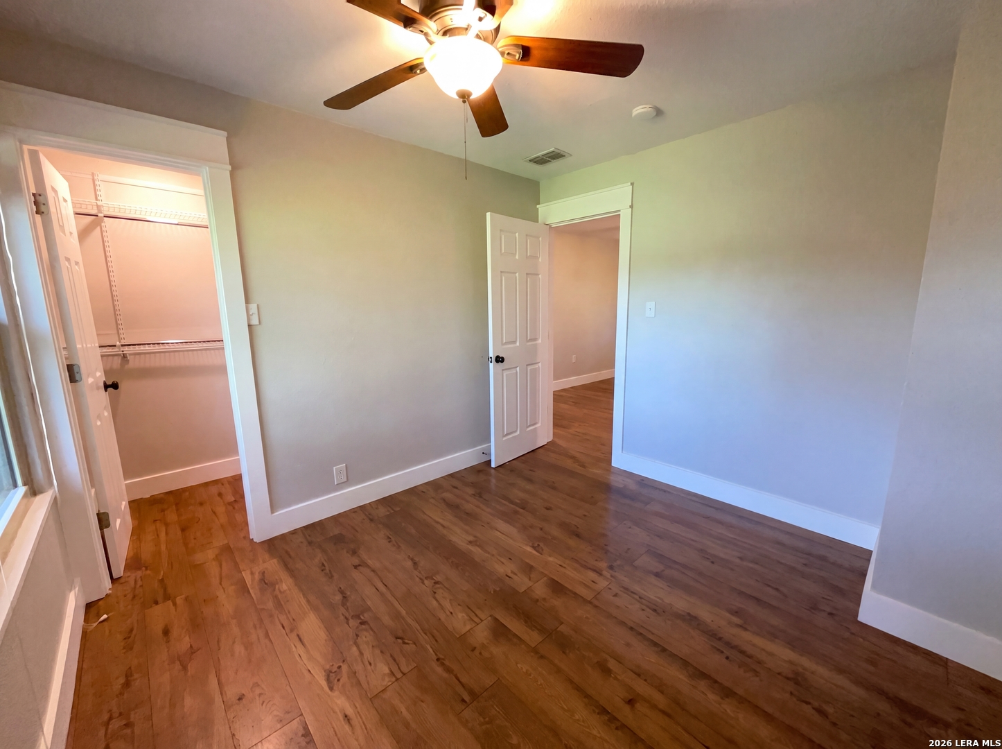 15422 Geronimo Loop San Antonio, TX 78254 - Photo 13 of 21 wooden floor in an empty room with a window