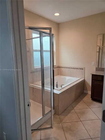 a bathroom with a tub and a shower