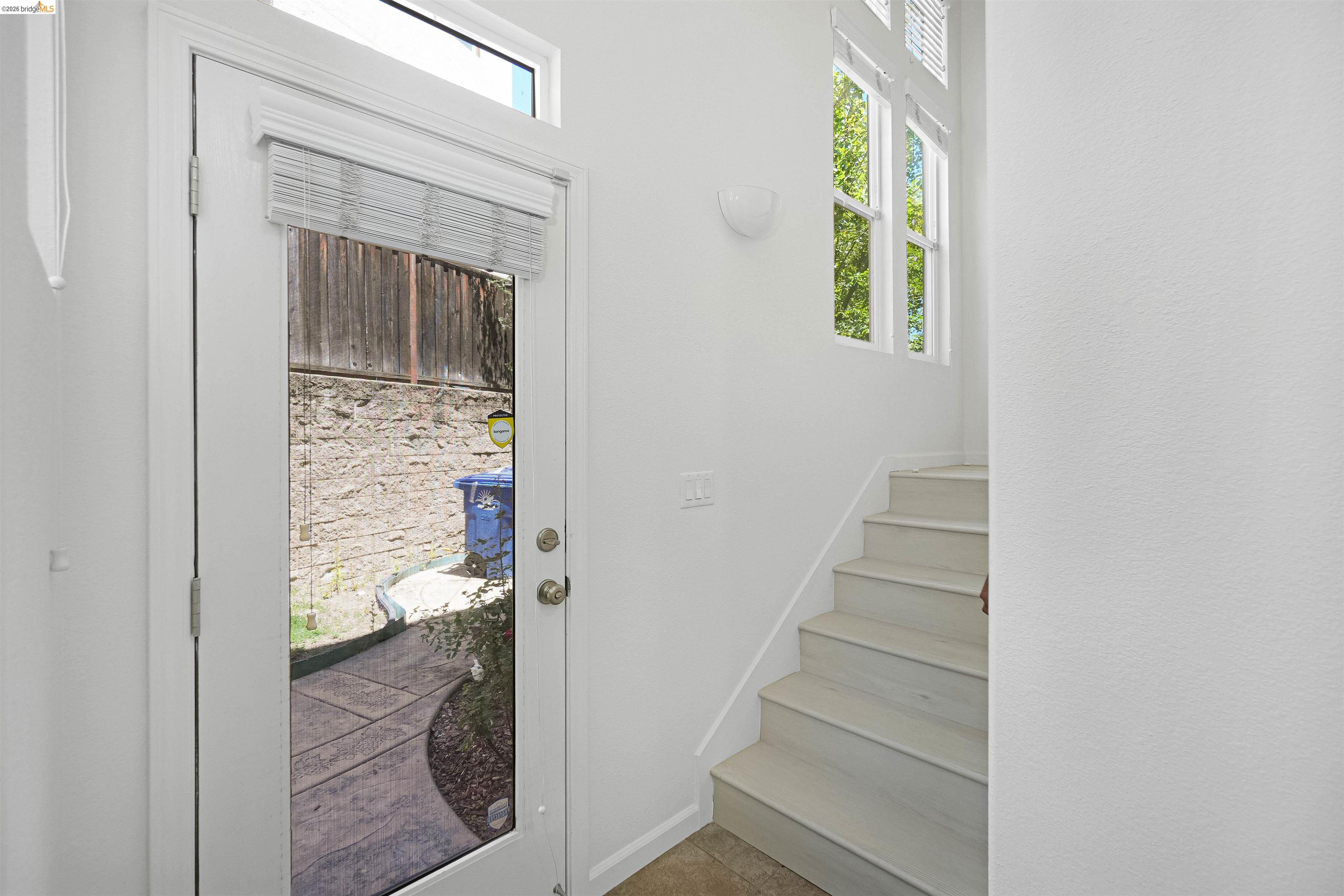 449 Constantine Court San Ramon, CA 94583 - Photo 47 of 63 Entryway featuring a full-light door with transom window, white interior walls, and light-toned stair treads