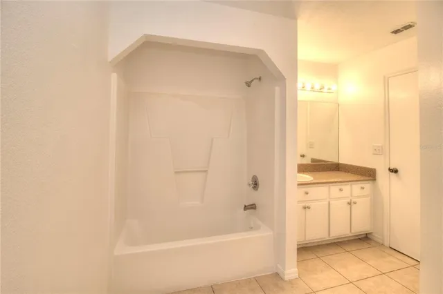 a bathroom with a bathtub and a sink