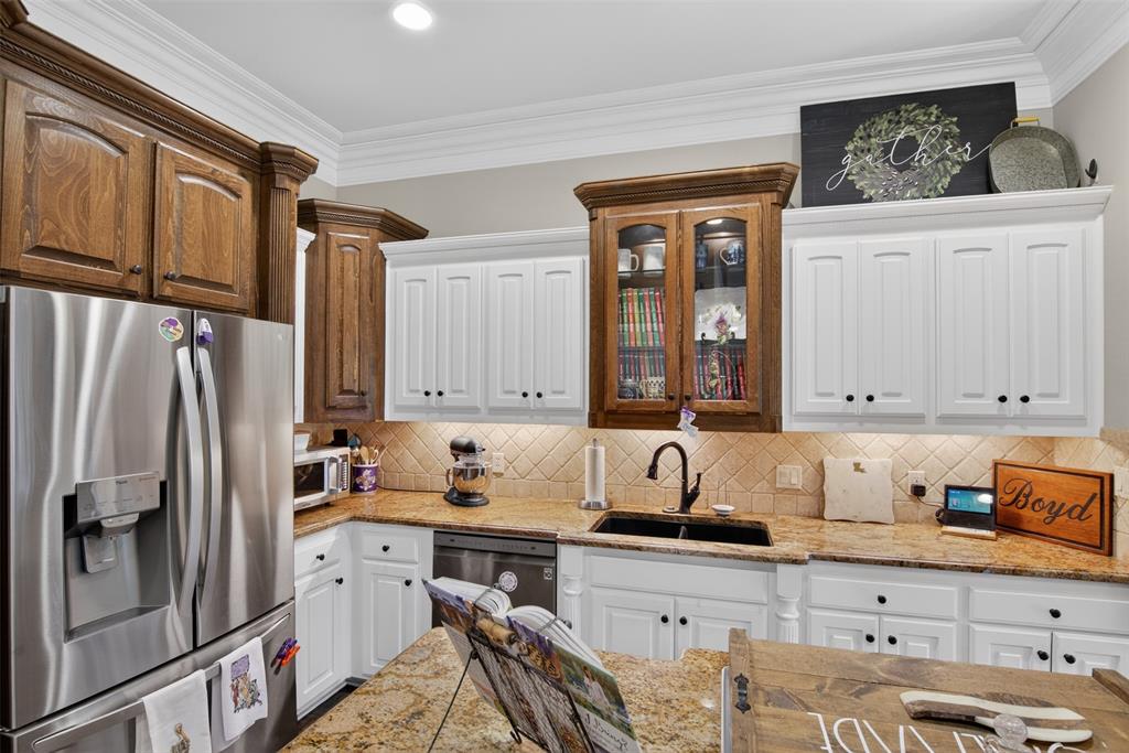 11868 Timber Ridge Drive Keithville, LA 71047 - Photo 11 of 37 Gourmet kitchen featuring a stainless steel French door refrigerator, black farmhouse sink, and under-cabinet lighting