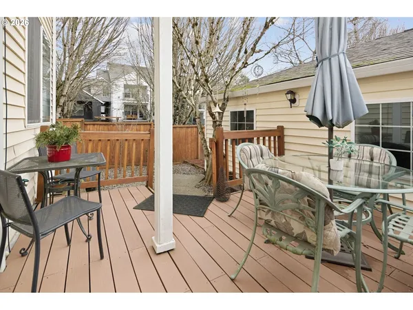 a view of a patio with couches table and chairs and wooden floor