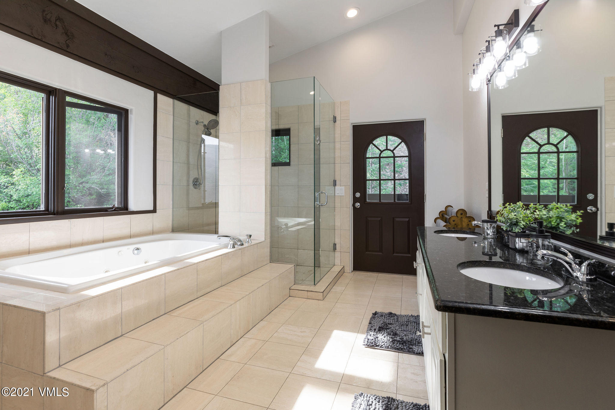 1074 Eagle Drive Eagle-Vail, CO 81620 - Photo 17 of 30 a spacious bathroom with a double vanity sink and a large mirror