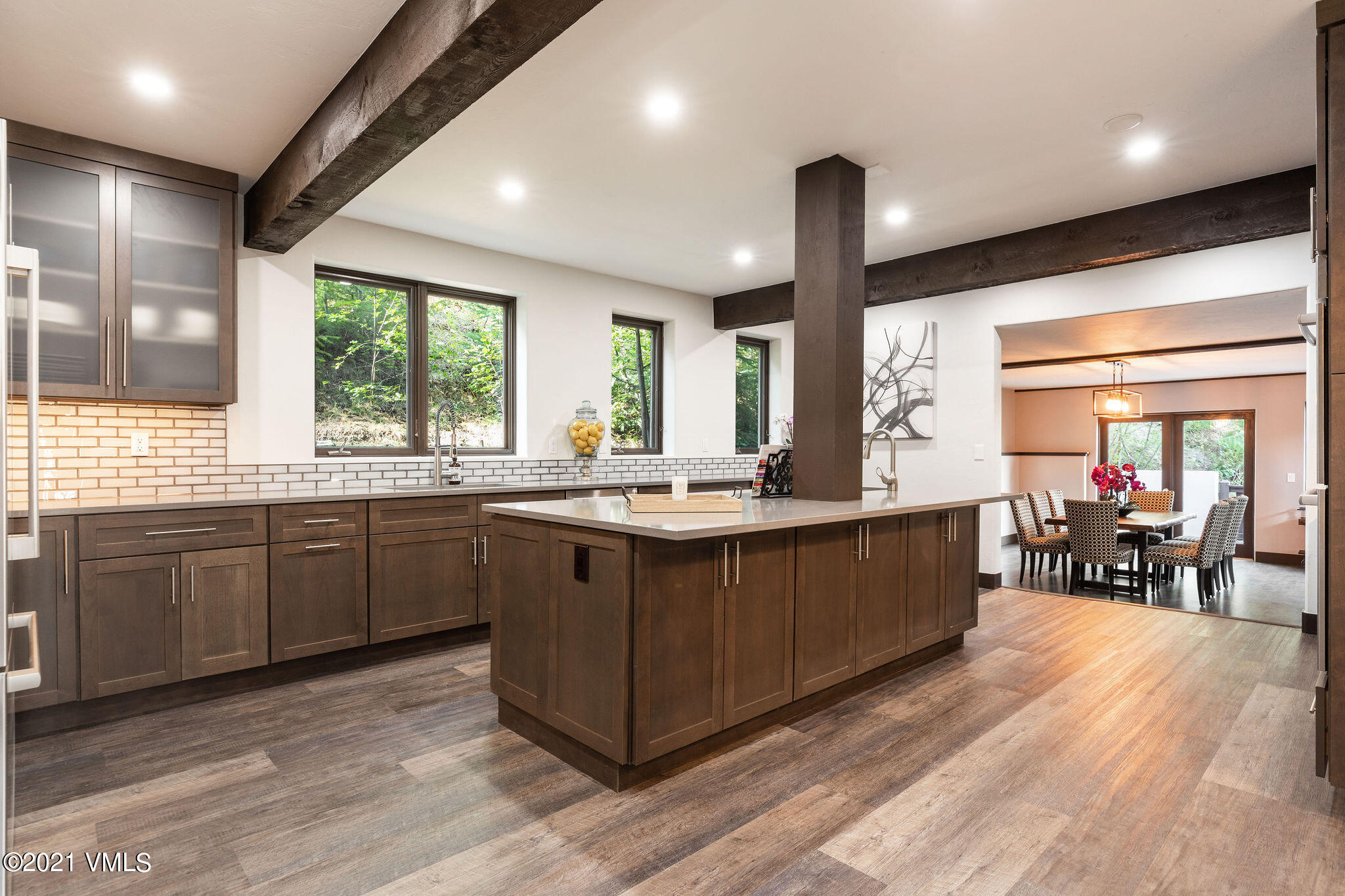 1074 Eagle Drive Eagle-Vail, CO 81620 - Photo 9 of 30 a kitchen with stainless steel appliances granite countertop sink stove dining table and chairs