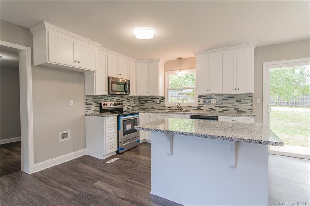 211 Anthony Road Rockwell, NC 28138 - Photo 3 of 22 a kitchen with granite countertop a sink cabinets and stainless steel appliances