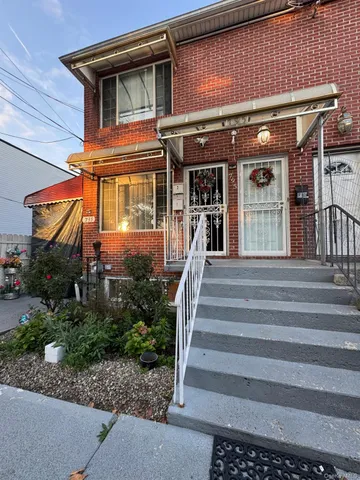 a front view of a house with entryway and windows