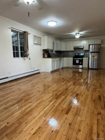 a view of a kitchen with a sink and a refrigerator