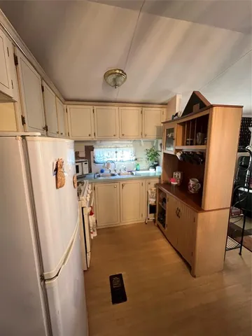 a kitchen with stainless steel appliances a refrigerator a sink a stove a microwave a sink and a refrigerator