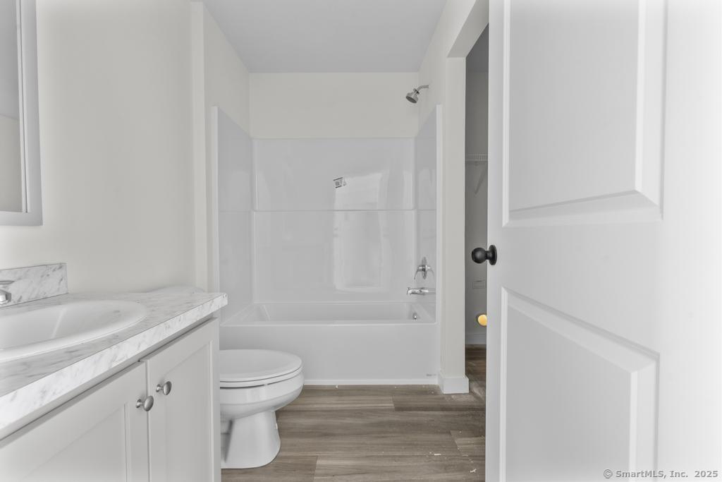 55 Sugar Street, Unit 10 Newtown, CT 06470 - Photo 12 of 18 a bathroom with a sink a toilet and shower