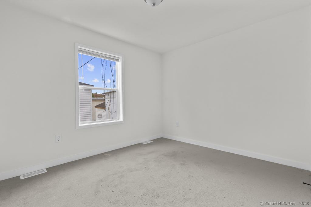 55 Sugar Street, Unit 10 Newtown, CT 06470 - Photo 13 of 18 a view of an empty room with a window