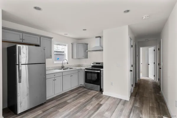 a kitchen with a refrigerator a sink and dishwasher