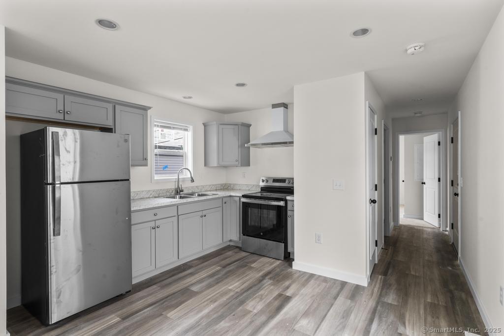 55 Sugar Street, Unit 10 Newtown, CT 06470 - Photo 4 of 18 a kitchen with a refrigerator a sink and dishwasher