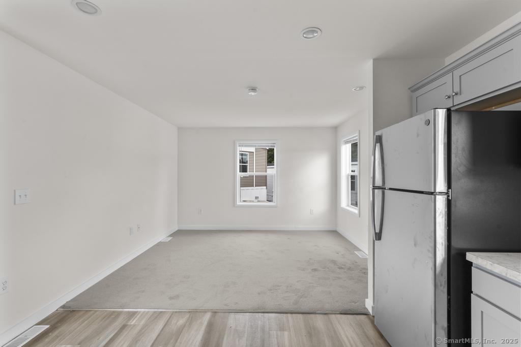 55 Sugar Street, Unit 10 Newtown, CT 06470 - Photo 6 of 18 a view of an empty room with a window