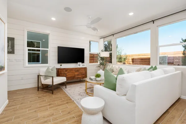 a living room with furniture a large window and a flat screen tv