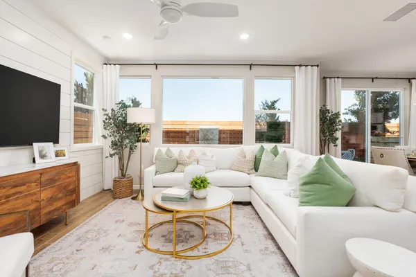 a living room with furniture kitchen and a table