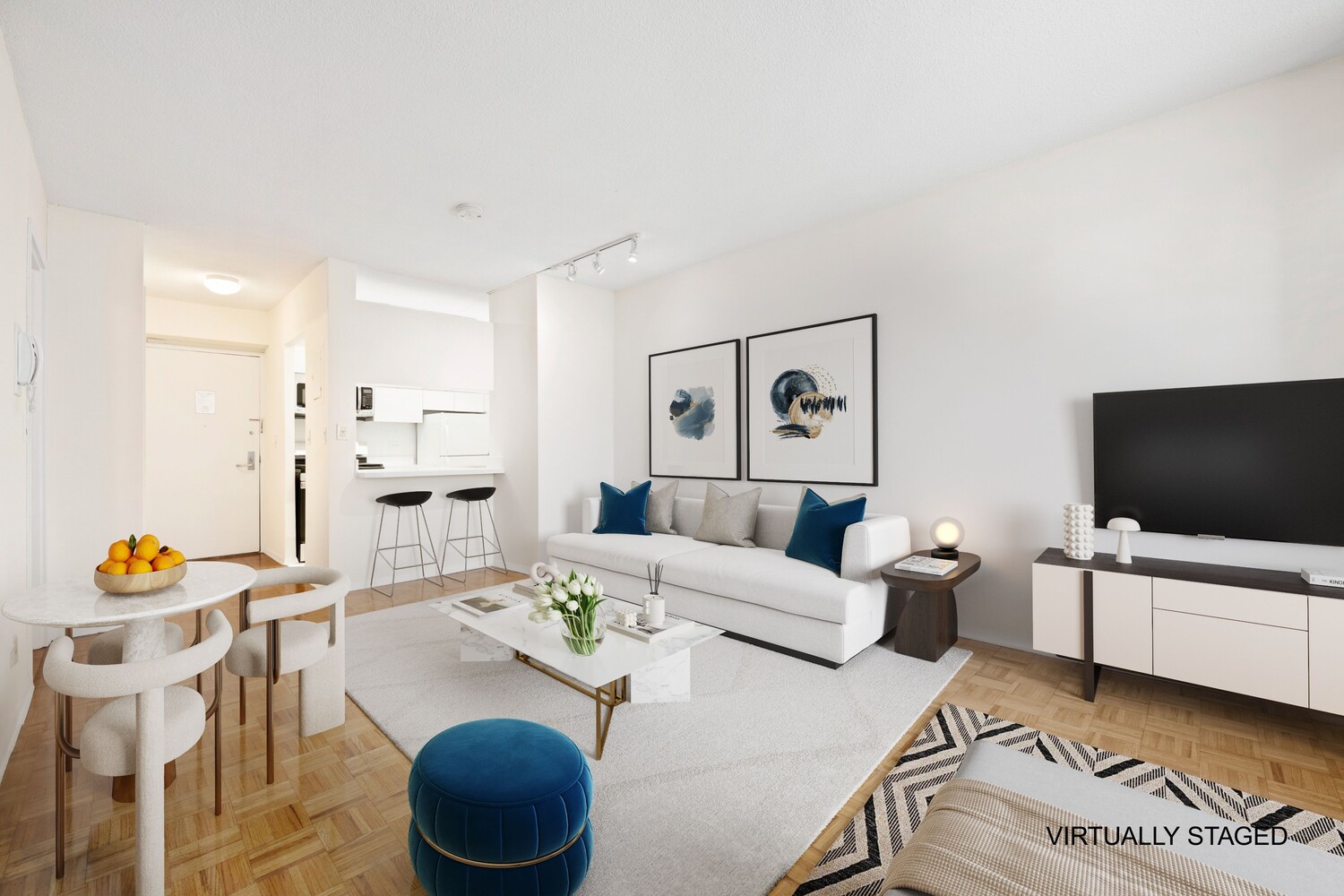 250 East 40th Street, Unit 21C Manhattan, NY 10016 - Photo 4 of 13 a living room with furniture and a flat screen tv