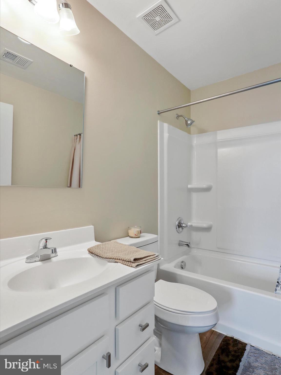 257 Switchgrass Court Bunker Hill, WV 25413 - Photo 15 of 26 a bathroom with a sink a toilet and shower