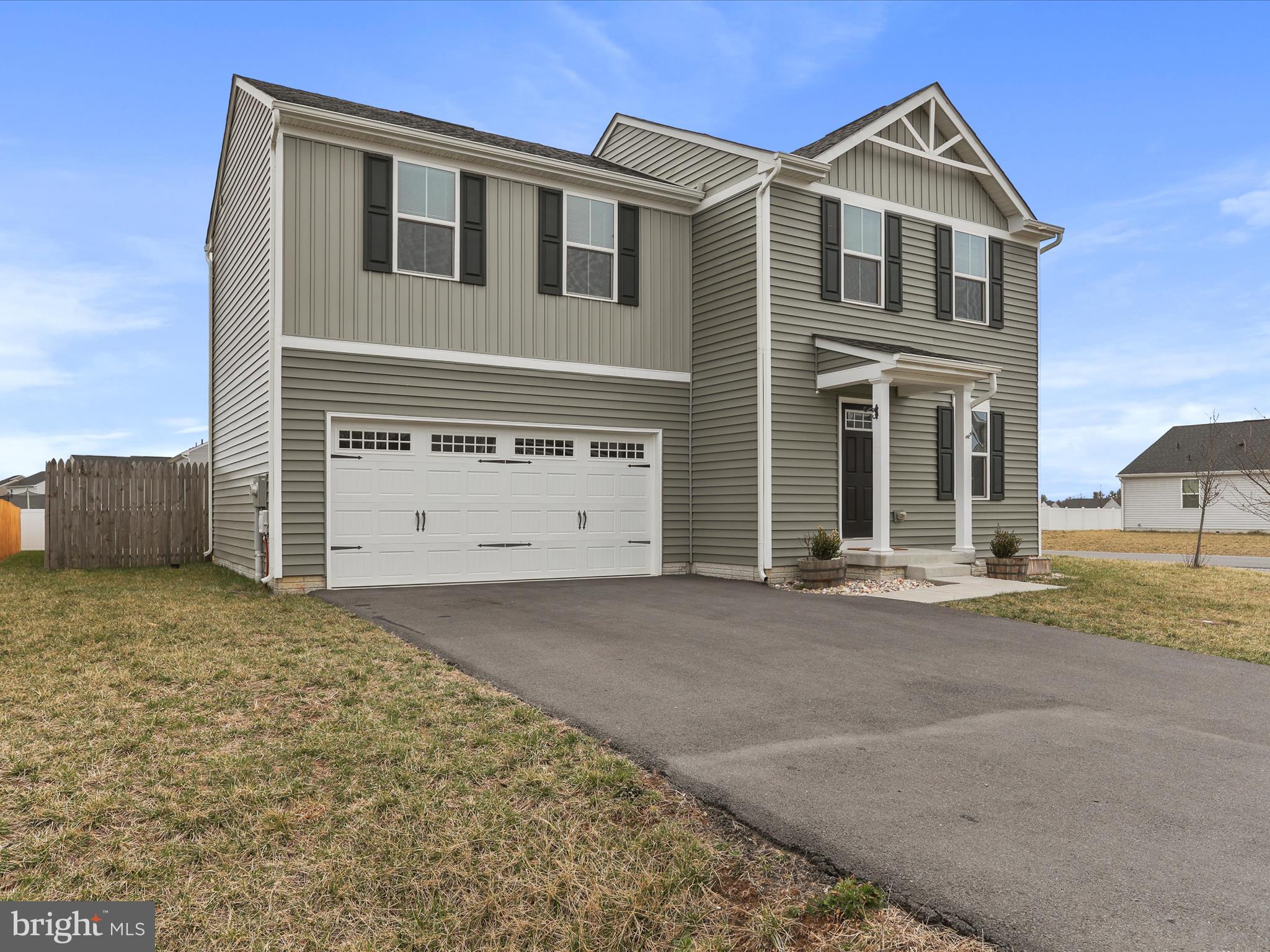 257 Switchgrass Court Bunker Hill, WV 25413 - Photo 2 of 26 a front view of a house with a yard and garage