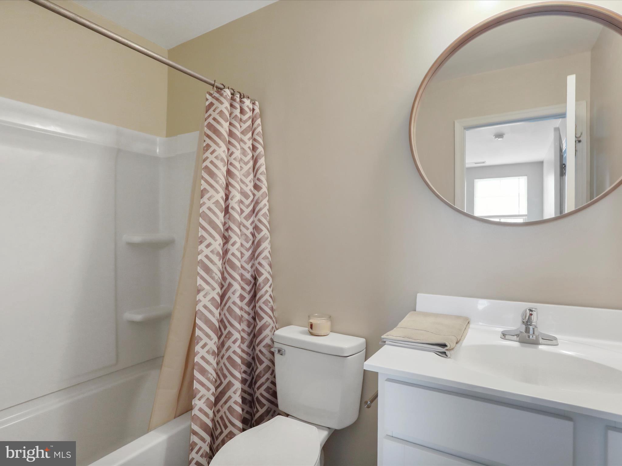 257 Switchgrass Court Bunker Hill, WV 25413 - Photo 21 of 26 a bathroom with a sink a toilet and a mirror