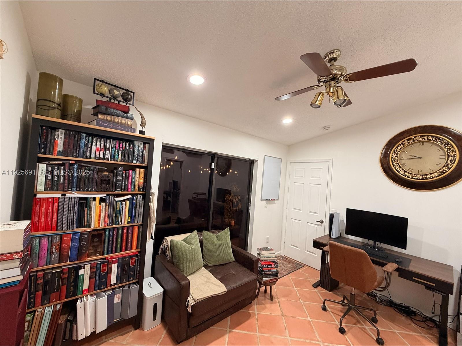 13680 Yarmouth Court, Unit C Wellington, FL 33414 - Photo 12 of 21 a living room with lots of furniture and a book shelf