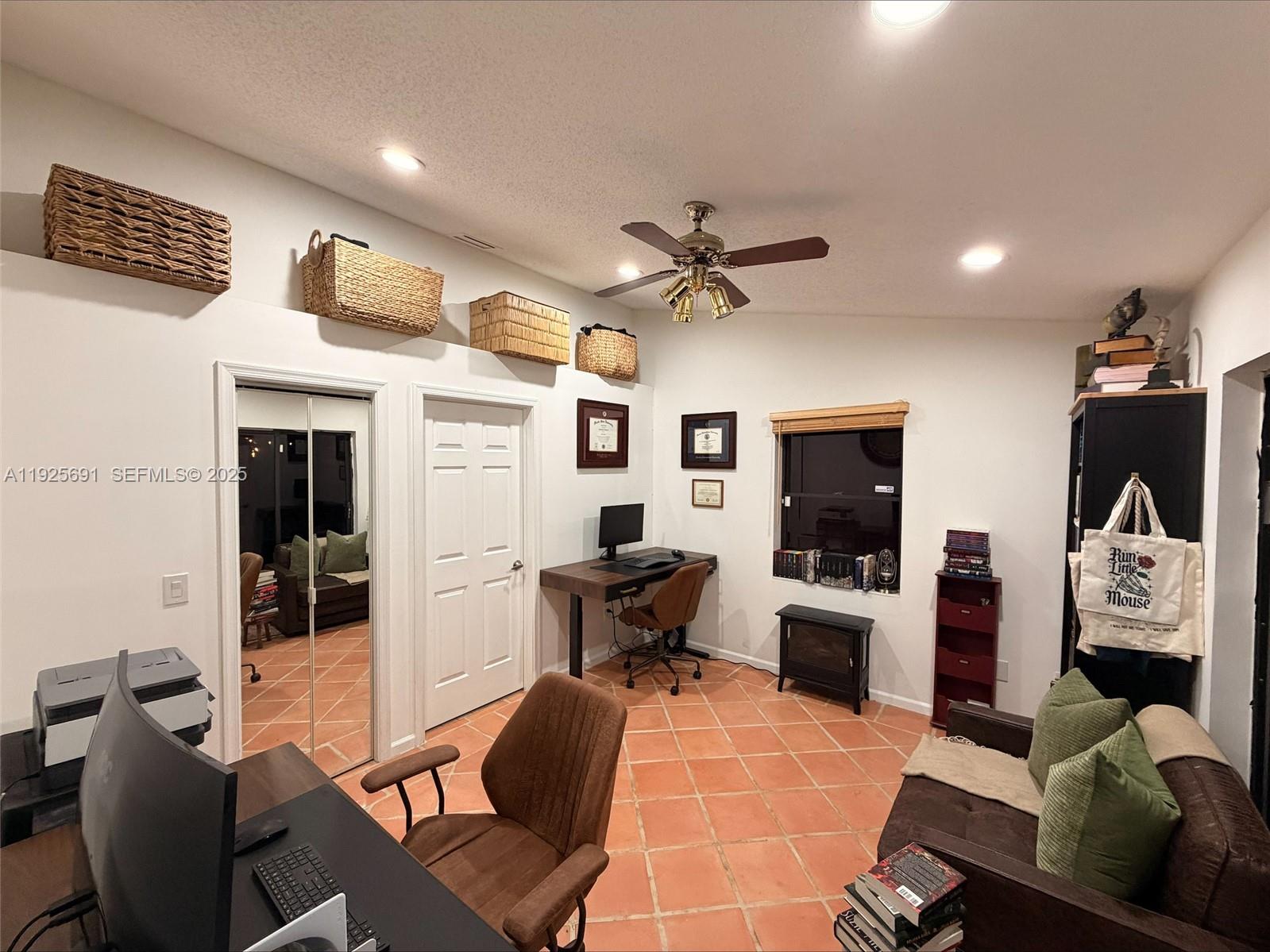 13680 Yarmouth Court, Unit C Wellington, FL 33414 - Photo 13 of 21 a living room with furniture and a flat screen tv