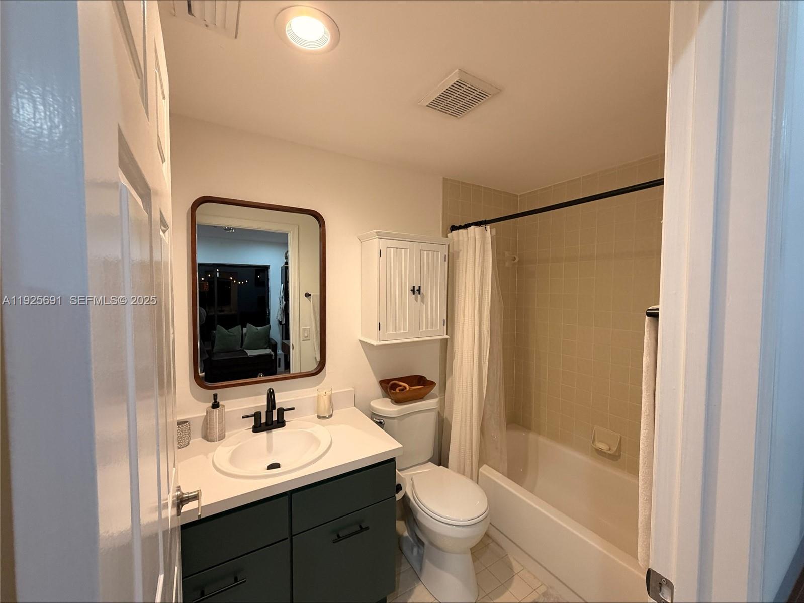 13680 Yarmouth Court, Unit C Wellington, FL 33414 - Photo 14 of 21 a bathroom with a toilet a sink and a mirror