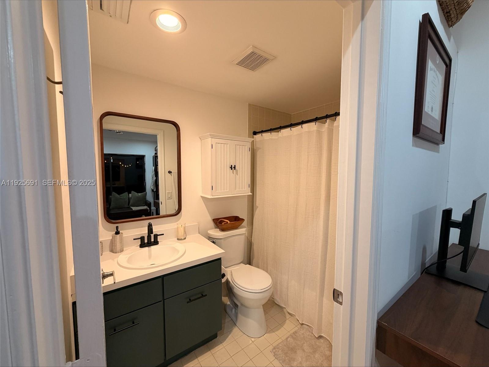 13680 Yarmouth Court, Unit C Wellington, FL 33414 - Photo 15 of 21 a bathroom with a toilet sink shower and mirror
