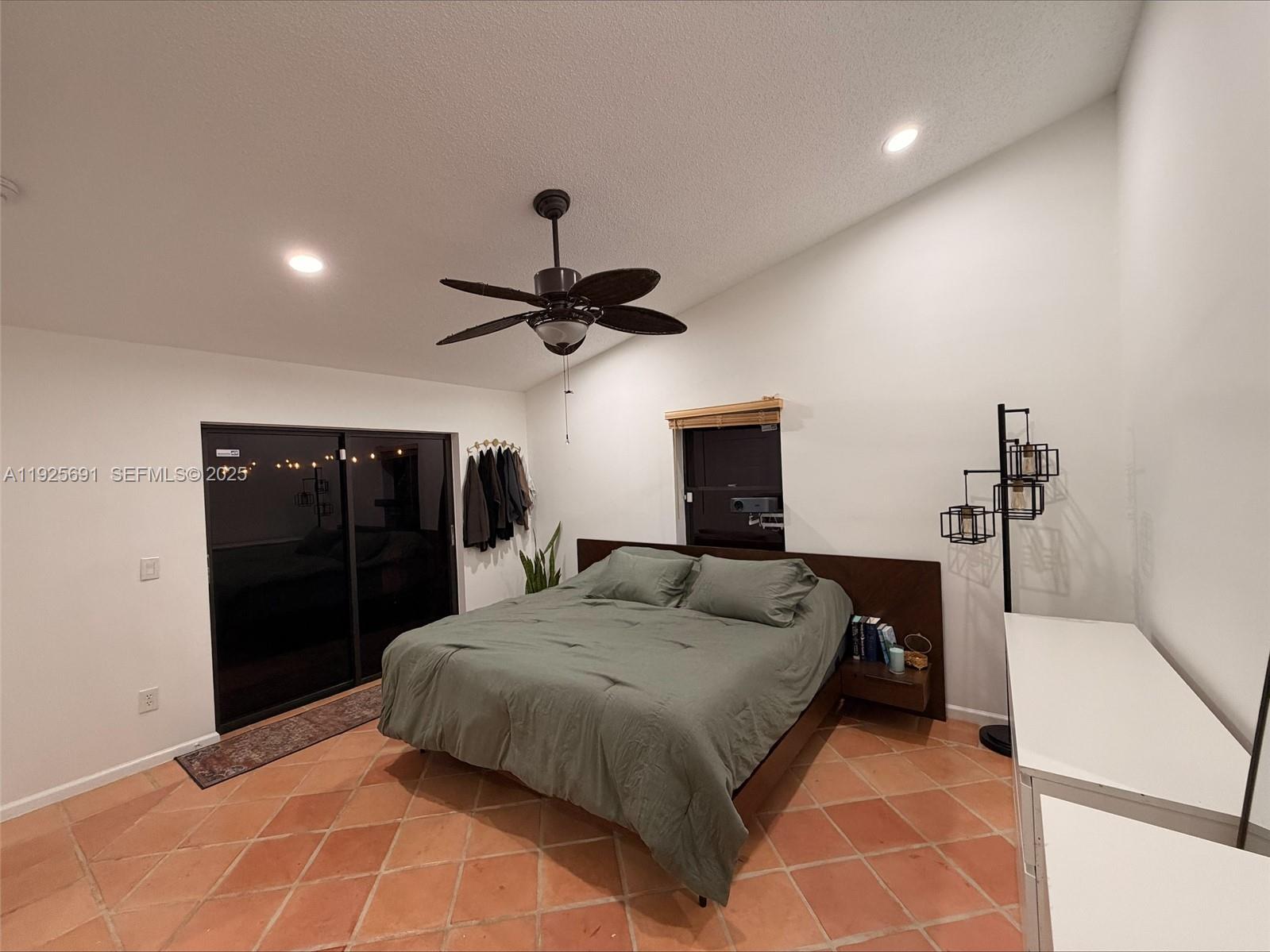 13680 Yarmouth Court, Unit C Wellington, FL 33414 - Photo 8 of 21 a bedroom with a bed and a walk in closet