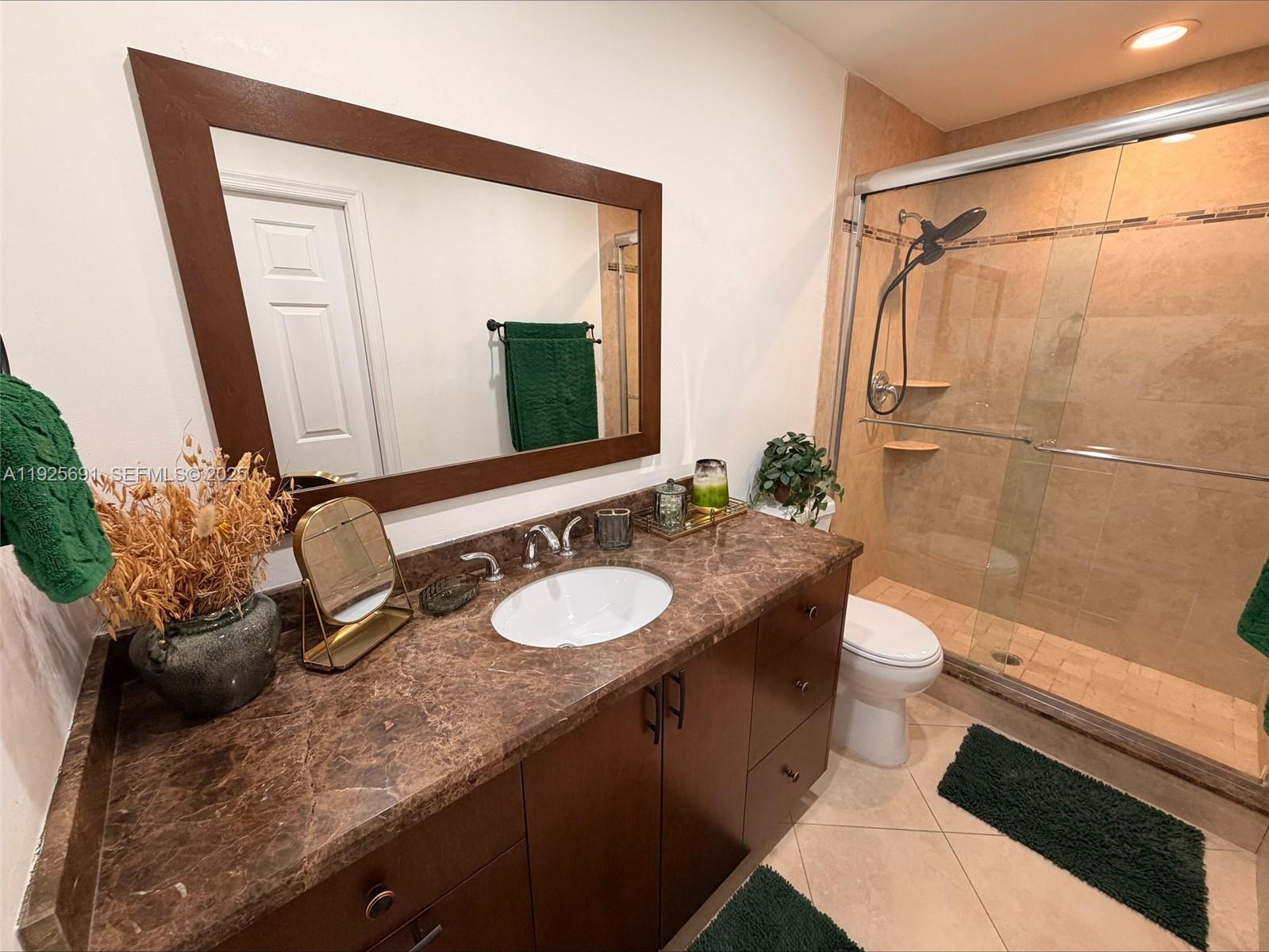 13680 Yarmouth Court, Unit C Wellington, FL 33414 - Photo 10 of 21 a bathroom with a granite countertop sink mirror vanity and toilet