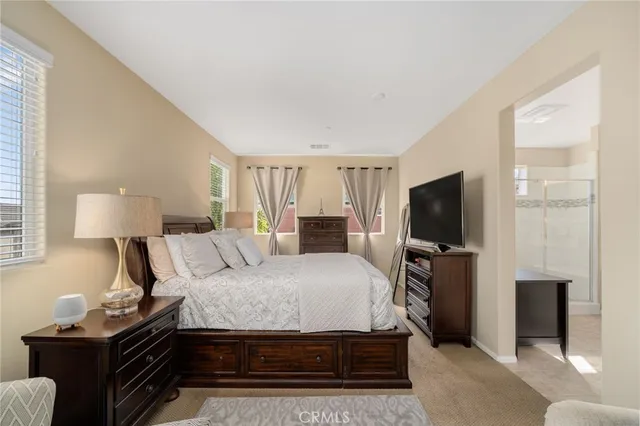 a bedroom with a bed and a flat screen tv