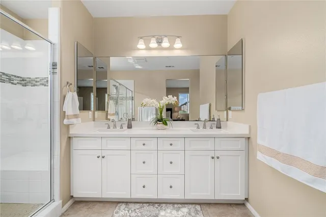 a spacious bathroom with a shower sink and mirror