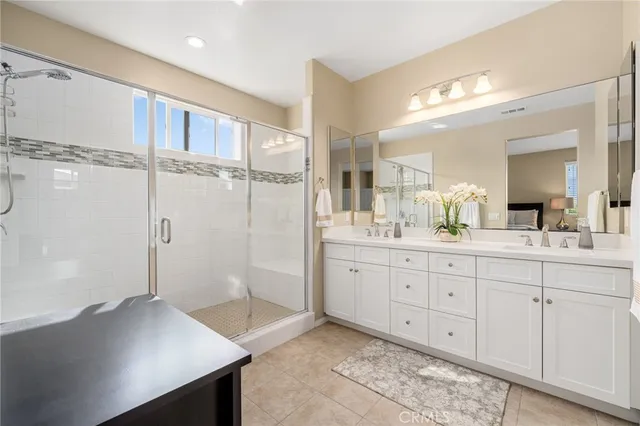 a bathroom with a shower sink and mirror