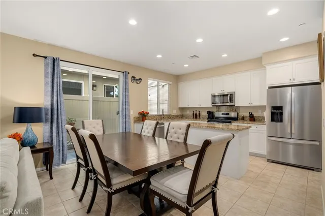 a view of a dining room with furniture and a flat screen tv
