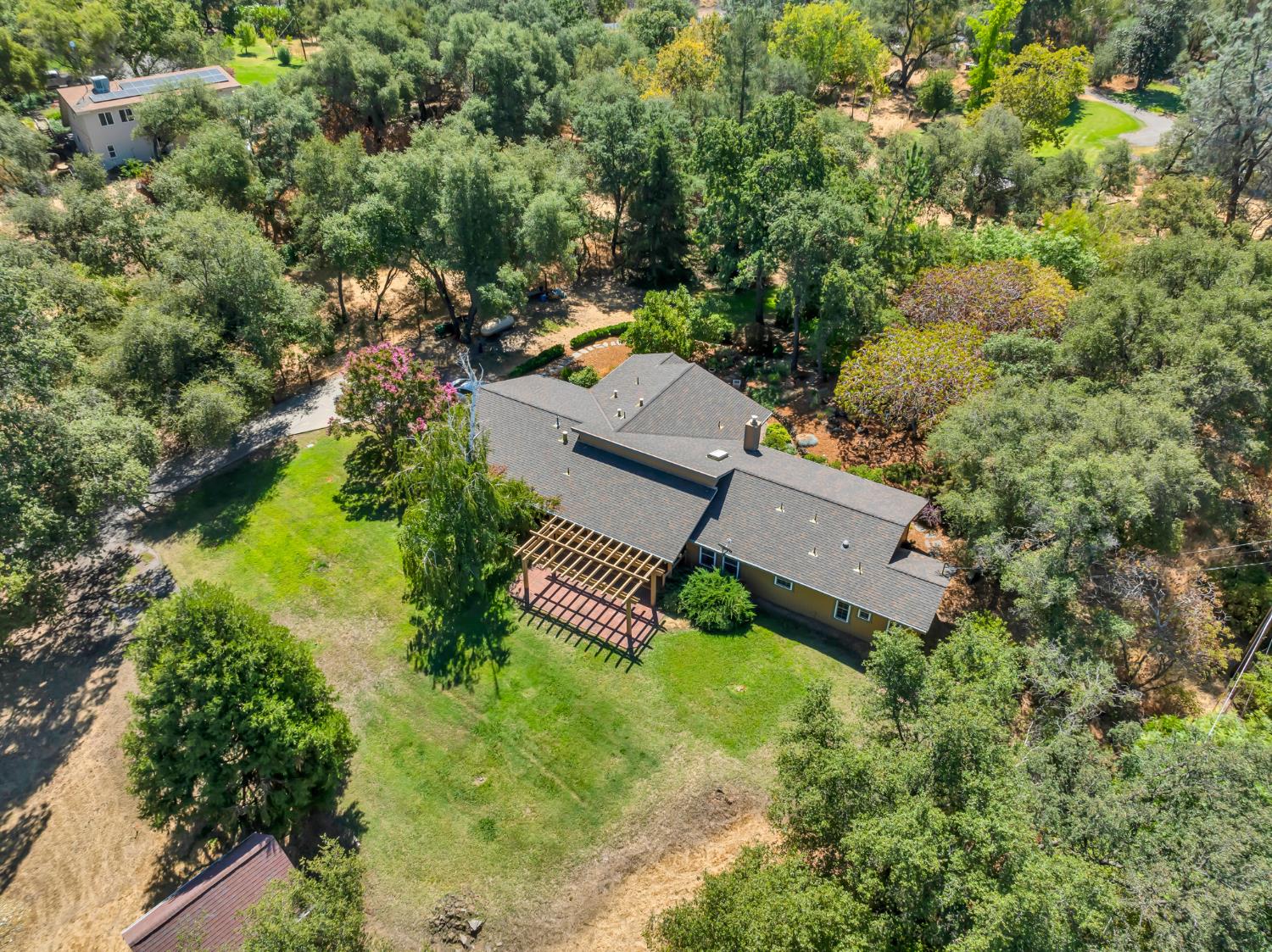 an aerial view of a house with garden space and street view