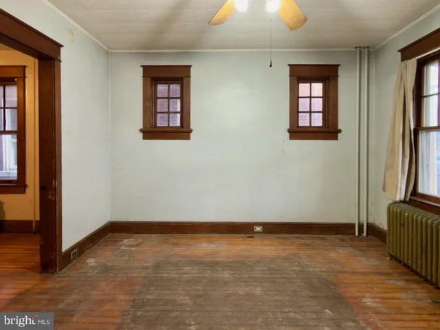 a view of hallway with wooden floor and stairs