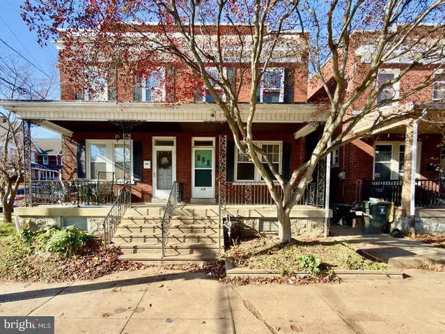 a front view of a house with outdoor seating
