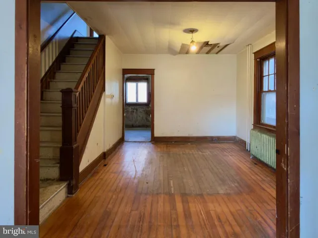 an empty room with closet and chandelier fan