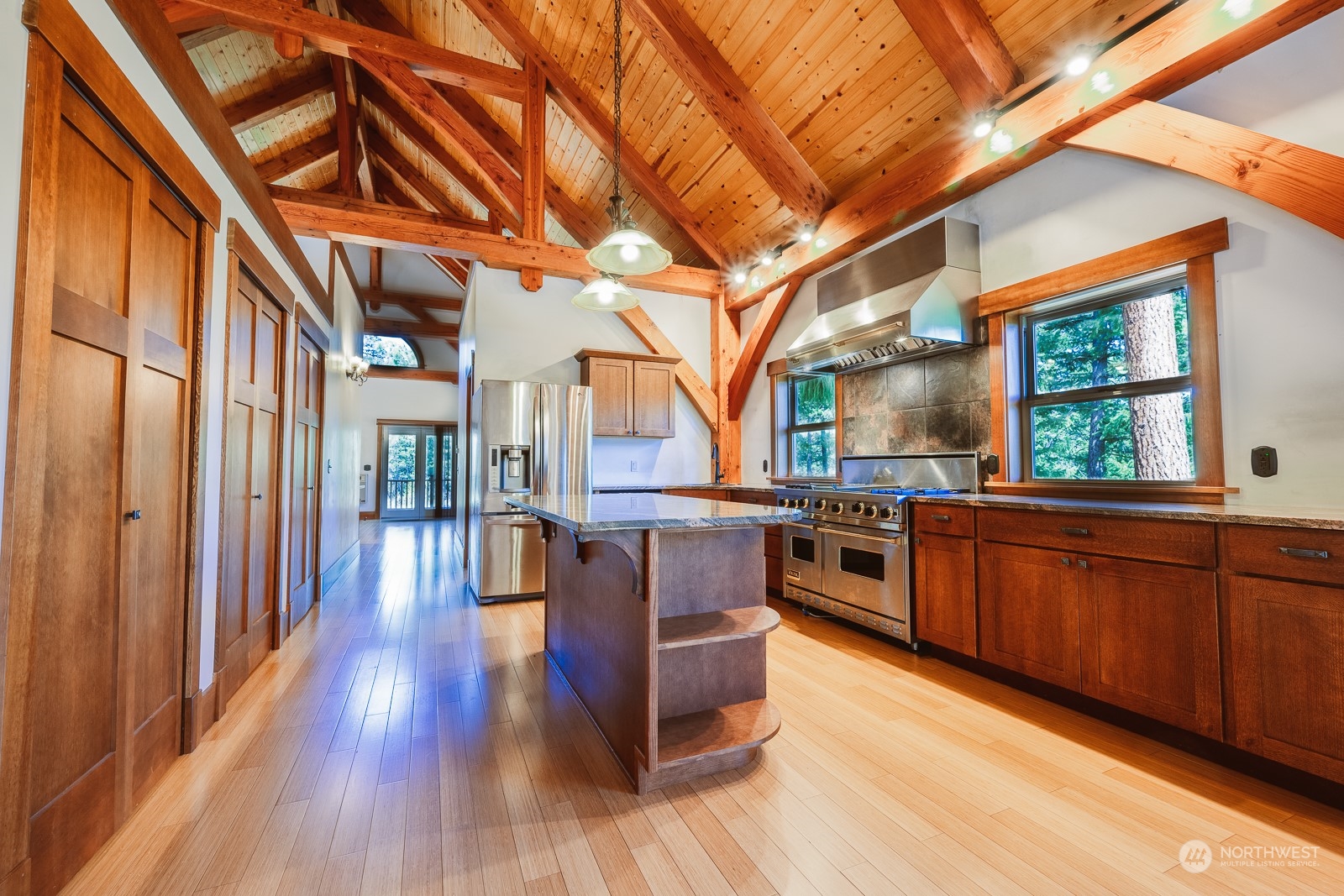 65 Fiddler's Road Winthrop, WA 98862 - Photo 13 of 25 a kitchen with stainless steel appliances granite countertop a stove and wooden floors