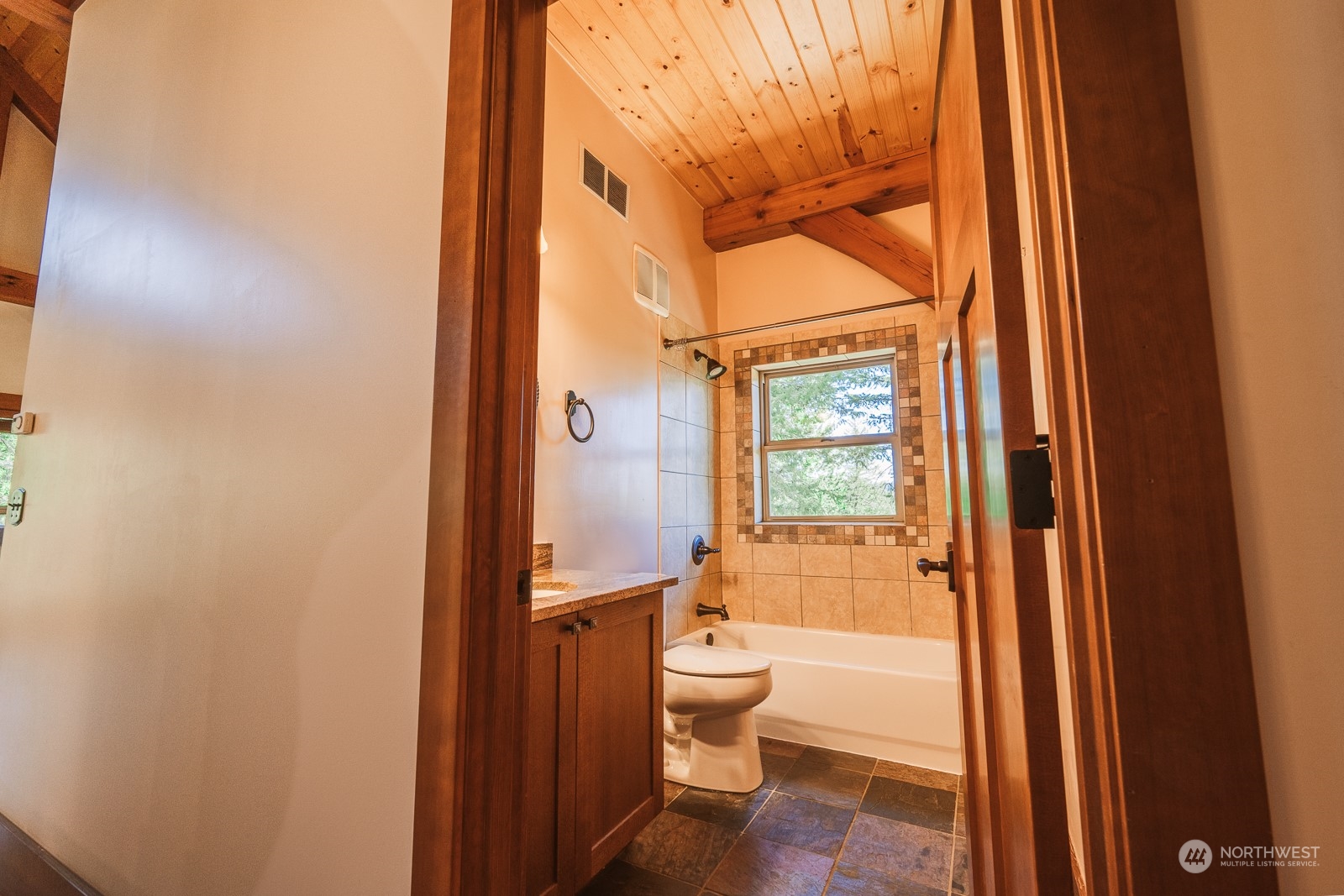 65 Fiddler's Road Winthrop, WA 98862 - Photo 15 of 25 a bathroom with a granite countertop toilet a sink and a large mirror
