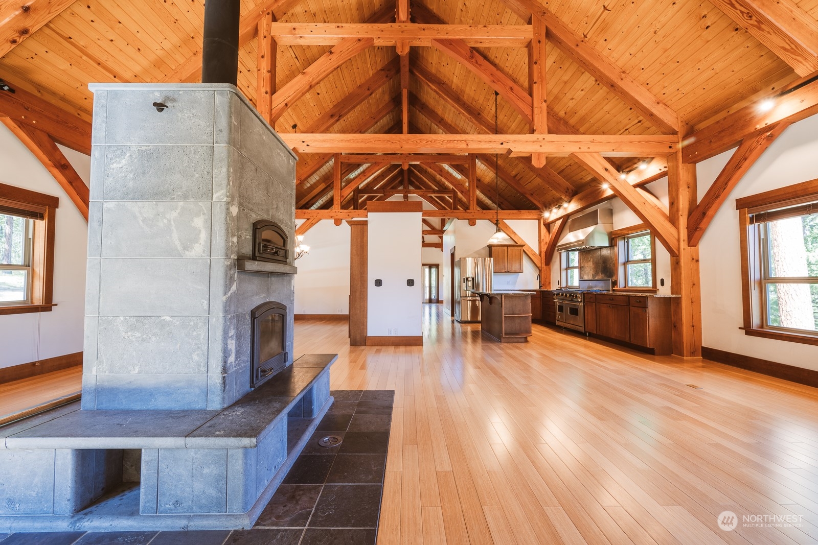 65 Fiddler's Road Winthrop, WA 98862 - Photo 6 of 25 a view of a patio with table and chairs under an umbrella with wooden floor