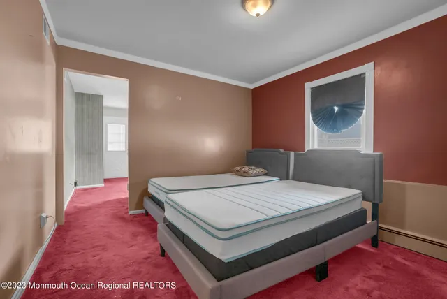 a bedroom with a bed and a mirror