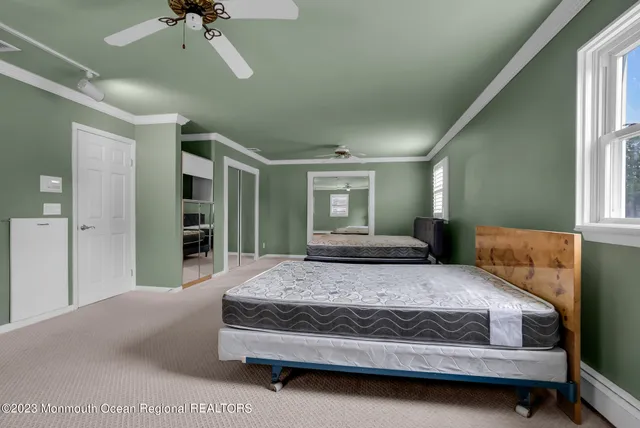 a bedroom with a large bed and a chandelier