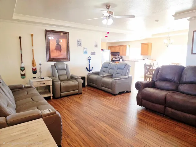a living room with furniture ceiling fan and a wooden floor