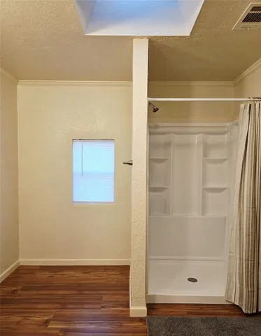 a bathroom with a glass shower door
