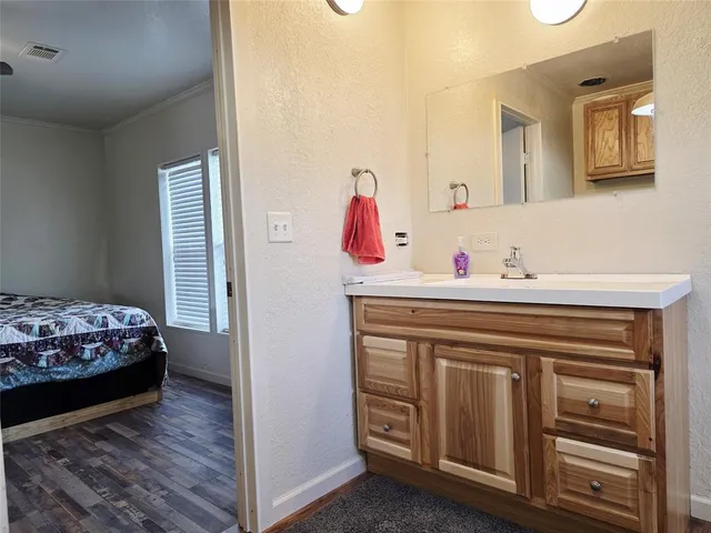 a bedroom with a bed and a dresser