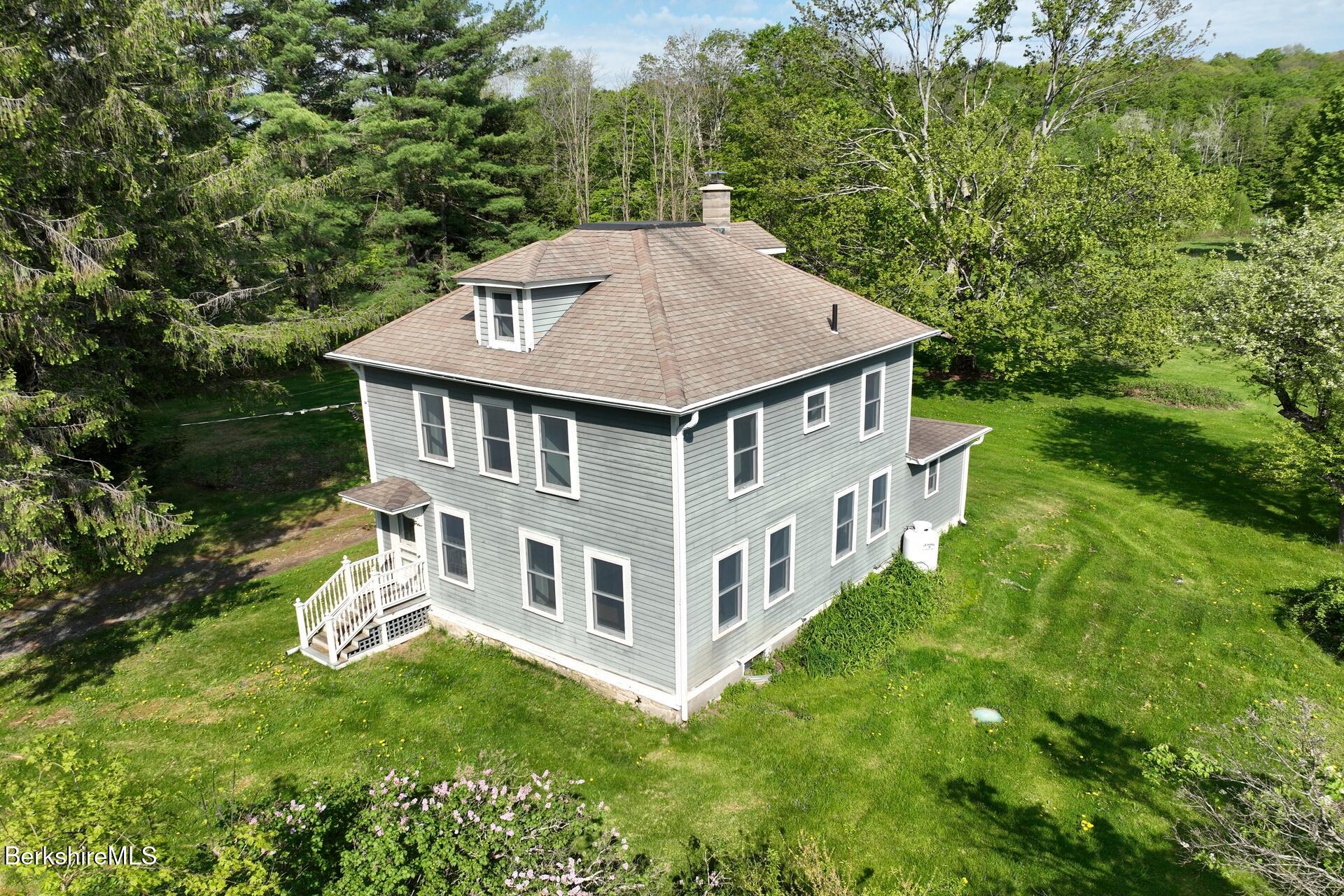 86 Miner Road Lanesborough, MA 01237 - Photo 1 of 44 a aerial view of a house with a yard table and chairs